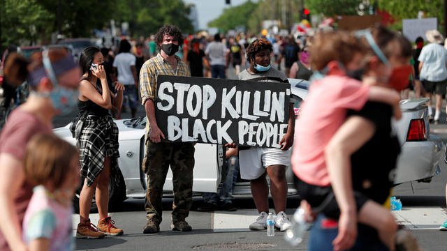 Protesters gather at the scene where Floyd was pinned down by a police officer in Minneapolis 
