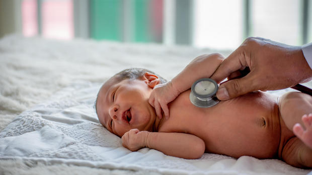 Soft blur of the doctor hands use stethoscope to check newborn baby health and take care him or cure the disease or disorder 
