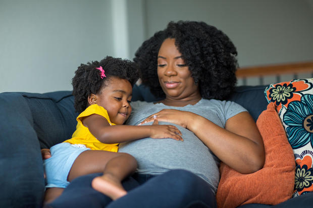 African American pregnant mother and her daughter. 
