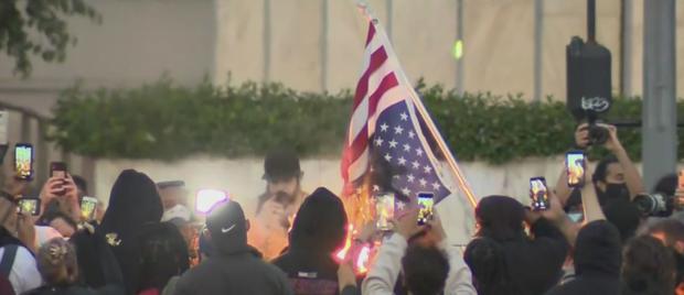 Protesters burn a flag downtown LA George Floyd 