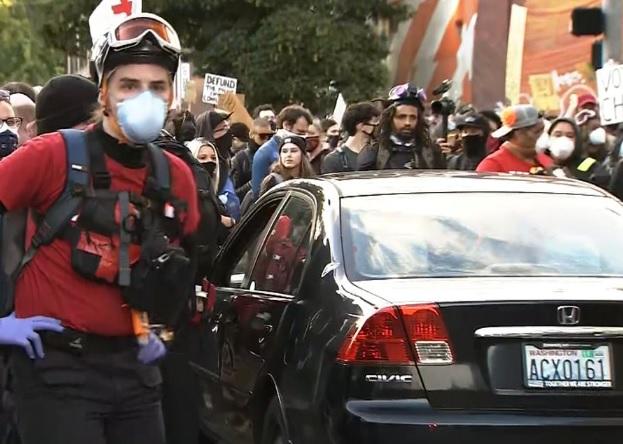 car-is-surrounded-by-grorge-floyd-protesters-in-seattle-shortly-after-it-was-driven-toward-them-on-060720.jpg 
