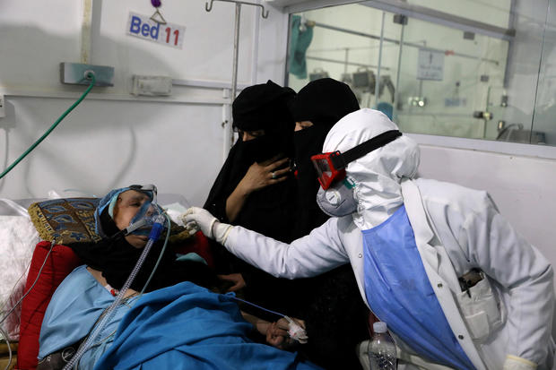 FILE PHOTO: Women watch as a nurse attends to their relative who is being treated at an intensive care unit of a hospital for the coronavirus disease (COVID-19) in Sanaa 