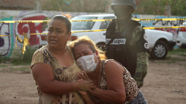 Women react outside a drug rehabilitation facility where assailants killed several people, according to Guanajuato state police, in Irapuato 