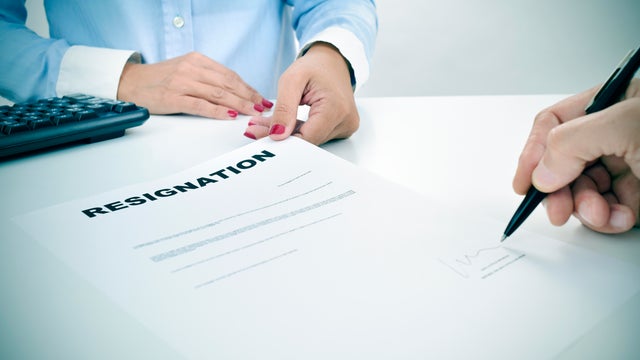 man signing a resignation document 