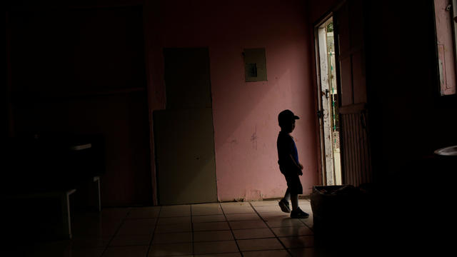 A Central American migrant child, asylum seeker sent back to Mexico from the U.S. under Migrant Protection Protocols (MPP) along his parents, is silhouetted at the Pan de Vida migrant shelter at Anapra neighborhood, in Ciudad Juarez 