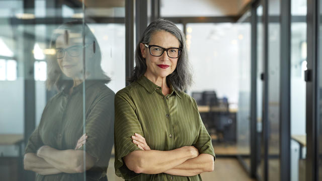 Confident mature businesswoman with arms crossed 