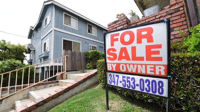 For Sale signs stand in front of houses in a neighborhood where many British people have purchased homes 