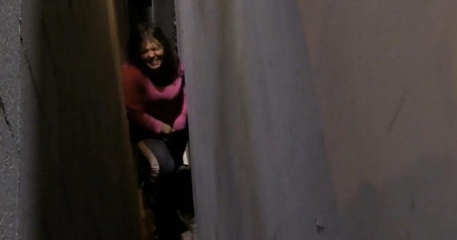 Woman in Calif. rescued after getting stuck between buildings - CBS News