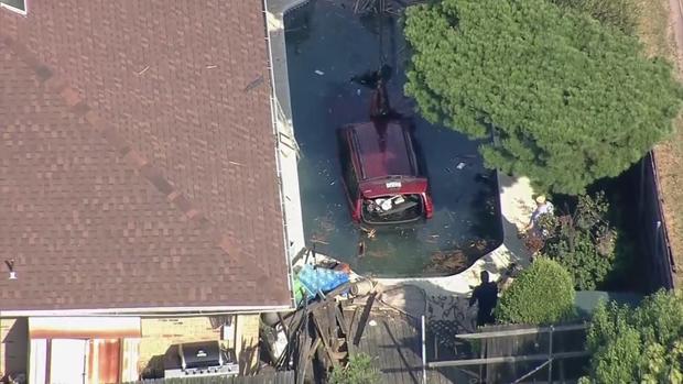 Vehicle in backyard pool in Arlington 