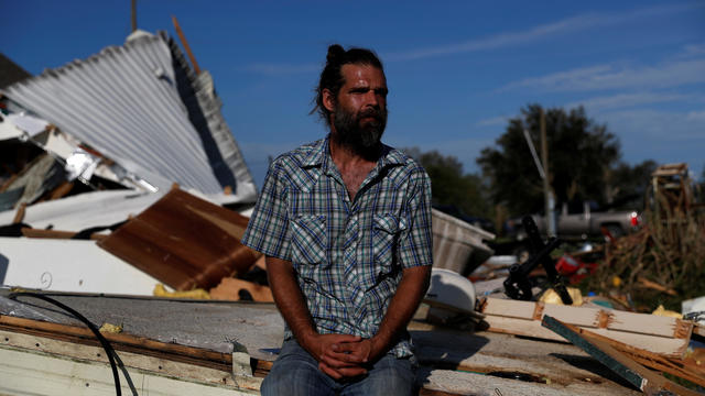 Rickey Guillory, 40, sits for a portrait on his demolished mobile home after Hurricane Laura passed through, outside of Kinder, Louisiana 