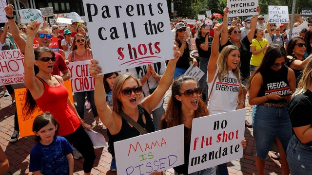 Demonstrators protest the mandatory flu vaccination for students in Boston 