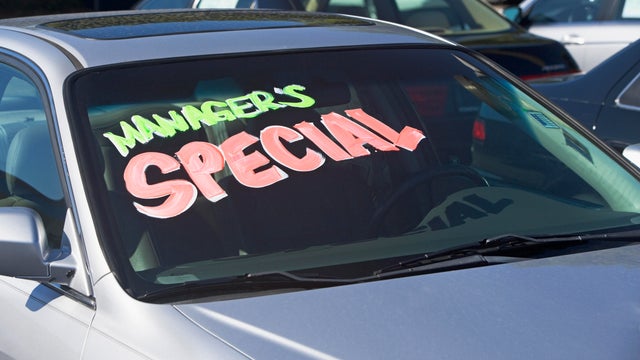 Cars are shown for sale at a car lot in California