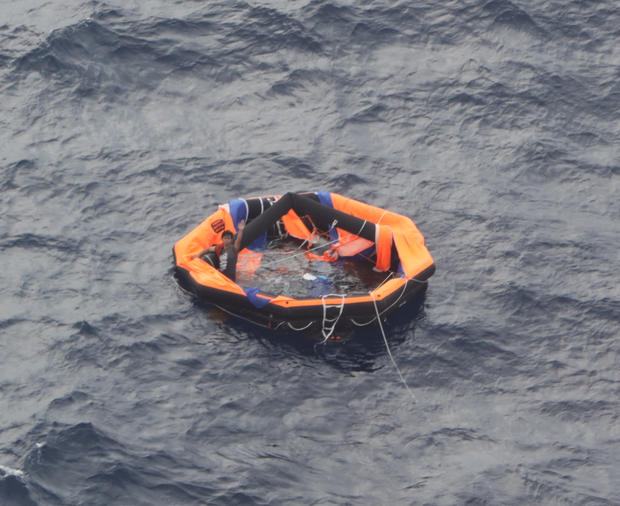 An aerial view taken from an airplane of Japan Coast Guard shows a Filipino crew member of the Gulf Livestock 1 on a life raft in the East China Sea 