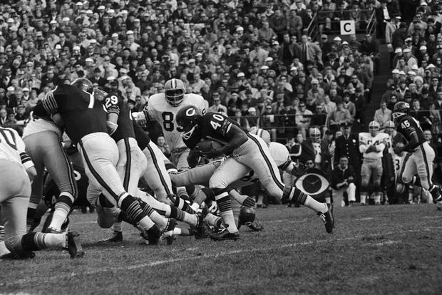 Gale Sayers Attempts to go Through Defensive Line 