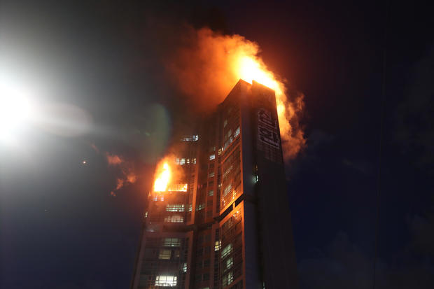 A mixed-use high-rise residential building is engulfed by a fire in Ulsan 