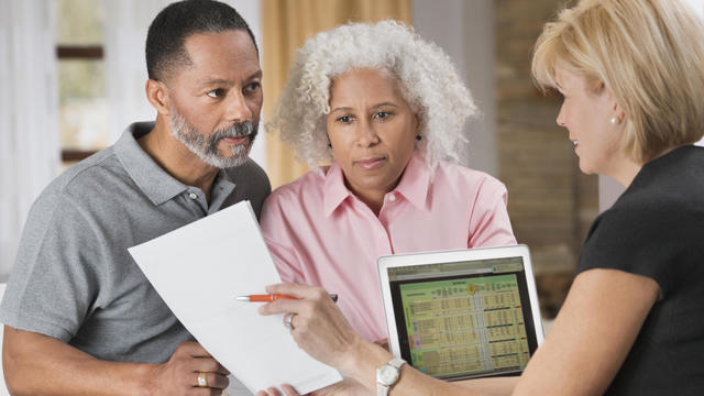 Older couple consulting with financial planner 