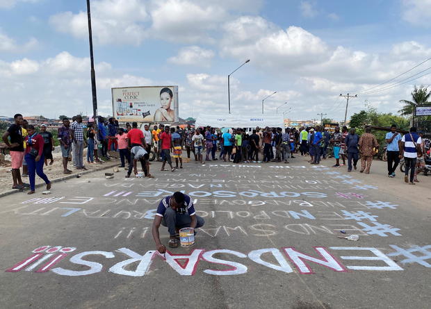 A demonstrator paints 'End Sars' during a protest demanding police reform in Lagos 
