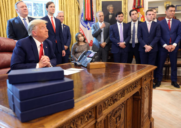 President Trump listens in the Oval Office on October 23, 2020, as Secretary of State Mike Pompeo, senior adviser Jared Kushner and national security adviser Robert O'Brien look on. 
