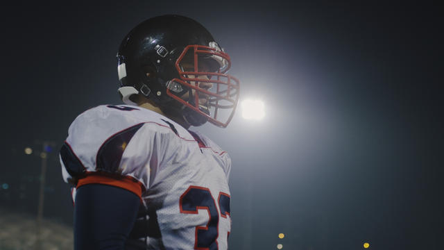 storyblocks-portrait-of-young-confident-american-football-player-standing-on-field-at-night_SAx9Pr7uz.jpg 