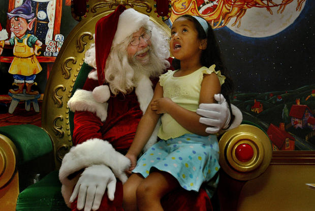 Sydneys oldest Santa, Santa Brian, listens to the Christmas wishes of Lyric Fid 