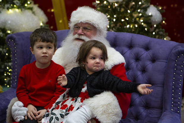 Some parents are questioning whether we should force crying children to sit on Santa's lap for photos, amid a national conversation about teaching children consent and children's boundaries. 