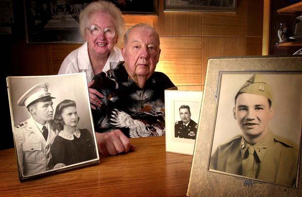 Retired Brig. General and former Colorado Supreme Court Justice Felix Sparks and his wife of 60 years, Mary, pose with portraits of themselves taken at various stages of his military career which began before WWII. From left: a wedding portrait taken in 1 