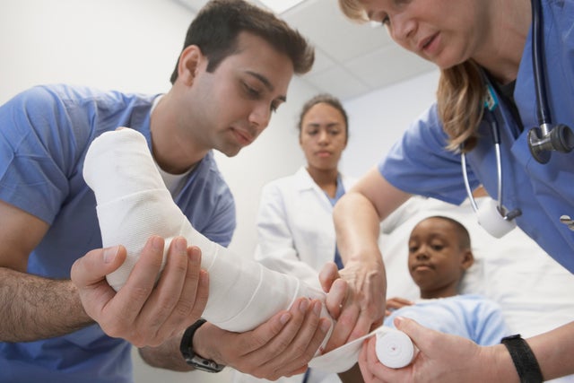 Doctors wrapping African boy's leg in hospital