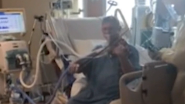 Grover Wilhelmsen plays the violin from his hospital bed in Utah. 