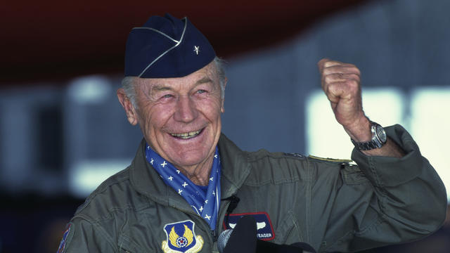 Chuck Yeager Raising Fist at Press Conference 