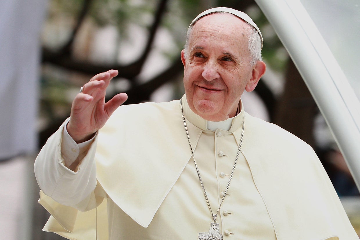 Pope Francis greets thousands of followers when he arrives at the Manila Cathedral on January 16, 2015, in Manila, the Philippines.