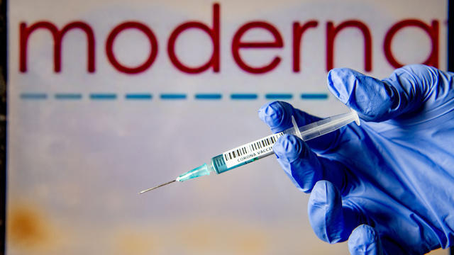 In this photo illustration, a man holds a syringe with a 