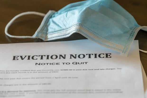Official legal eviction order or notice to renter or tenant of home with face mask 