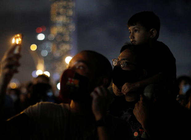 People watch a light show, as the traditional New Year's Eve fireworks are cancelled due to the coronavirus disease (COVID-19) outbreak, at Marina Bay in Singapore 