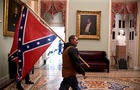 Trump supporter carries a Confederate flag in the U.S. Capitol 