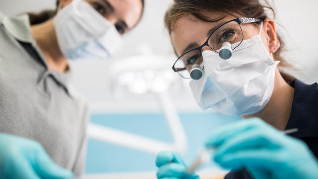 Female dentist examining patient 