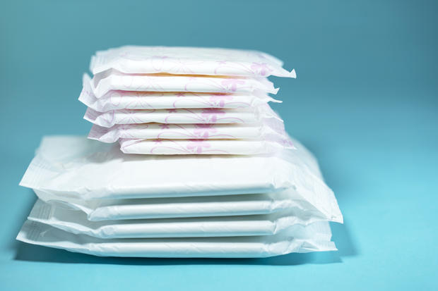menstrual period Sanitary pads and absorbent sheets on blue background 