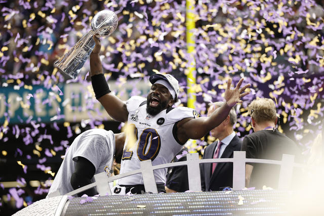 Baltimore Ravens safety Ed Reed celebrates with the Lombardi trophy with  line backer Ray Lewis looking on at Super Bowl XLVII at the Mercedes-Benz  Superdome on February 3, 2013 in New Orleans.
