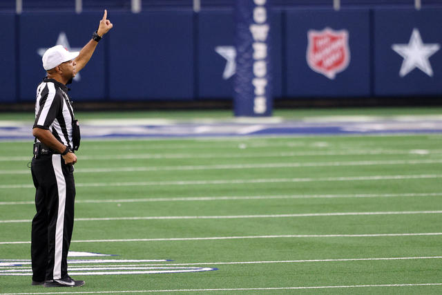 Referee Adrian Hill (29) watches a replay in the first half of an