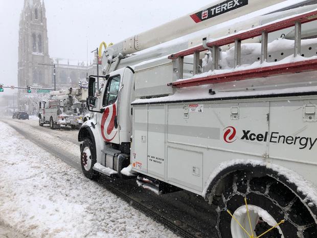 Xcel Energy trucks driving in the snow 