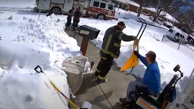 aurora-firefighters-shovel-walk-for-man-in-wheelchair.jpg 