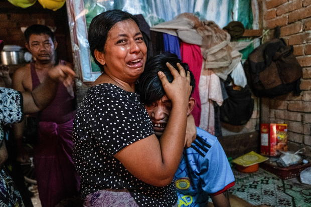 Family members mourn a man after he was shot dead during anti-coup protests, in Yangon 