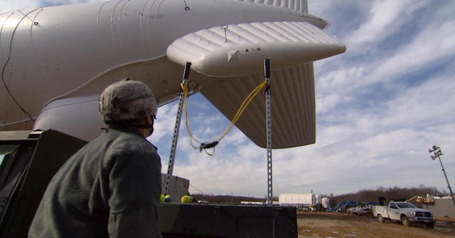 Slingshot and tennis balls shoot snow, ice off Army blimp CBS News