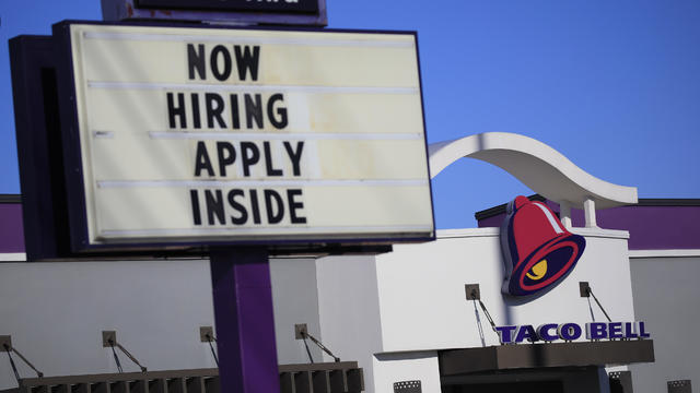 "Now hiring" sign outside Taco Bell 