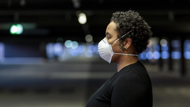 young woman wearing a protective face mask to prevent the spread of virus in the city 