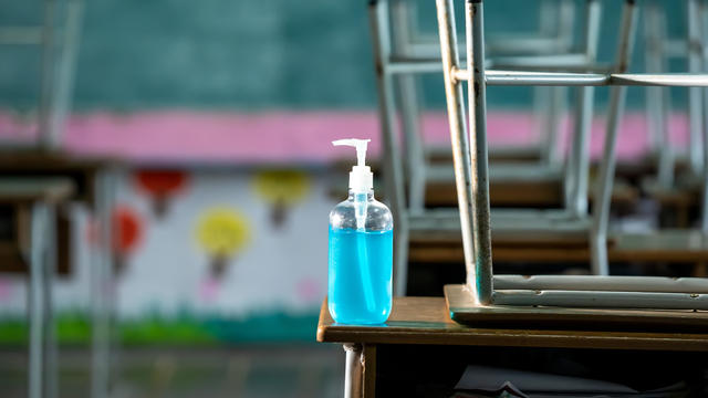 Disinfectant at elementary school student classroom desk. 