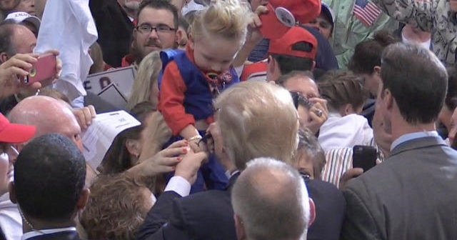 Donald Trump signs baby at rally - CBS News