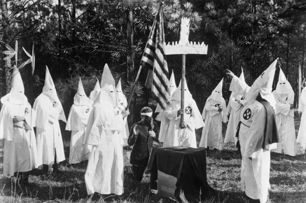 Klansman Holding Cross at Ku Klux Klan Ceremony 