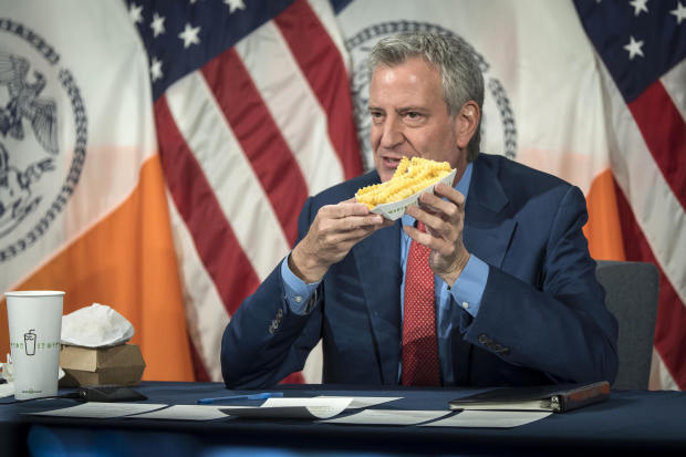 New York Mayor Bill de Blasio holds up a side of Shake Shack fries at City Hall on May 13, 2021. 