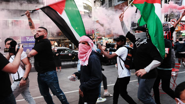 Pro-Palestinian protesters face off with a group of Israel supporters and police in a violent clash in Times Square in New York City. 