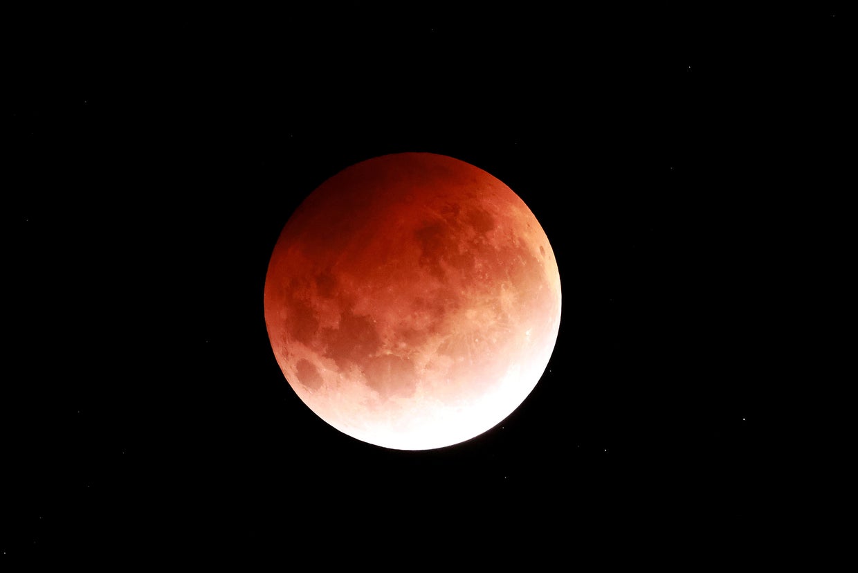 Rare "super flower blood moon" lunar eclipse captured in stunning